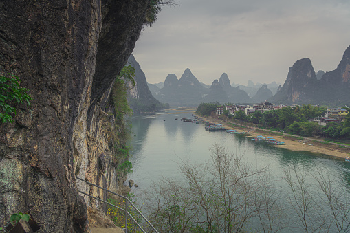 View of the Li River (Lijiang River) with azure water among scenic karst mountains at Yangshuo County of Guilin, China. Green hills on blue sky background. Amazing summer sunny landscape.