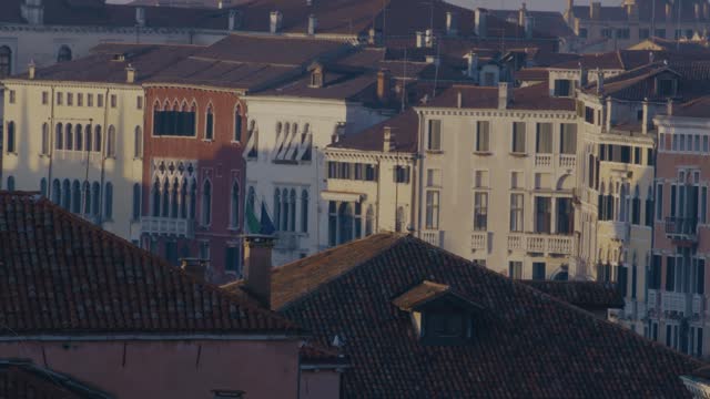Venetian Gothic windows overlook terracotta rooftops