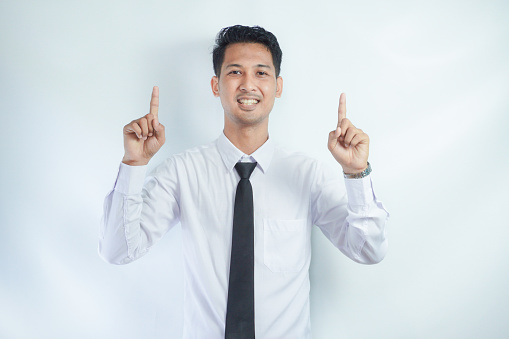 Adult Asian man smiling happy with both hands pointing up