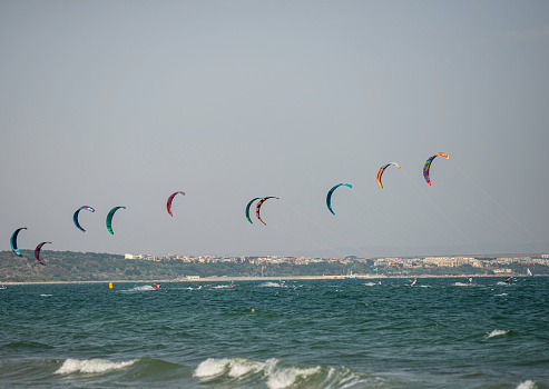 Many colorful kites in different shapes on the beach at Cervia international kite festival \