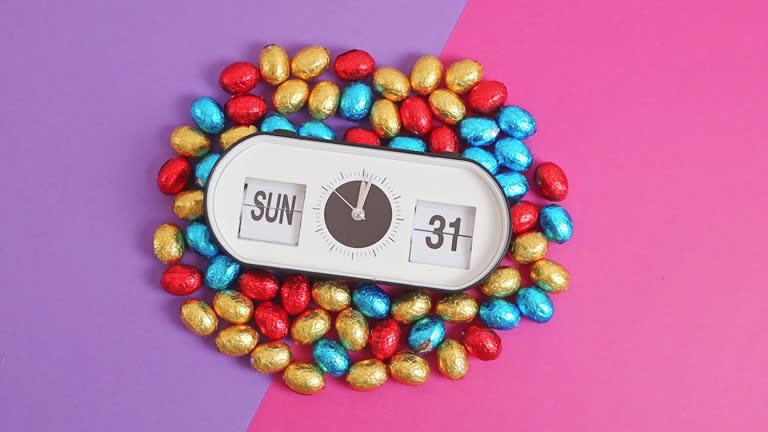 Alarm clock with Easter time and date and Easter eggs on lilac pink.