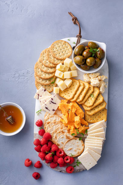 istock Small cheese and cracker board with fresh berries and olives 2149187710