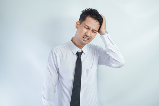 Adult Asian man got painful headache gesture