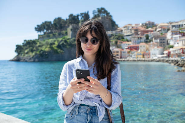 istock Young woman on vacation using smartphone. 2149188659