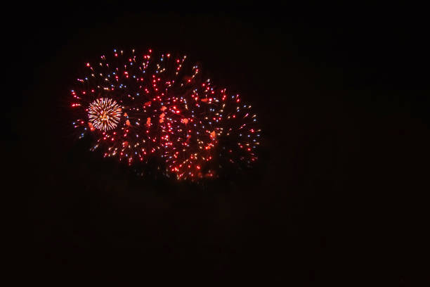 Fireworks explode in bright colors. Light up the night sky in red, green, gold and blue.