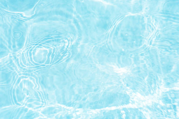 istock Bluewater waves on the surface ripples blurred. Defocus blurred transparent blue colored clear calm water surface texture with splash and bubbles. Water waves with shining pattern texture background. 2149191595