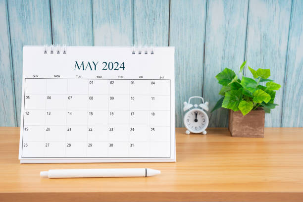 istock May Monthly desk calendar for 2024 year and alarm clock. 2149193278