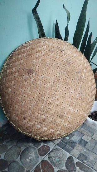 Tampah, winnowing, or nyiru is household furniture, made from woven bamboo