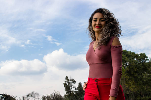 istock Beautiful young woman posing in a public park 2149193648