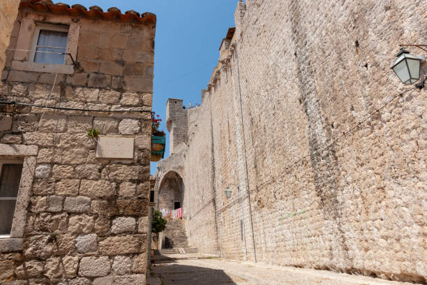 Inside wall of medieval city high wall leads to steps in medieval walled city of Dubrovnik.