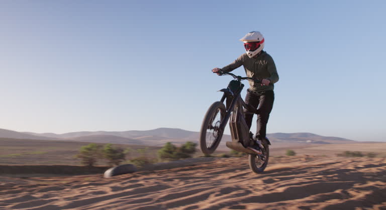 Motorbike, speed and man on sand trail with motorcross, power and rider outdoors. Driver, electric bike and male person travel or riding on dirt track, performance and action or talent for freedom