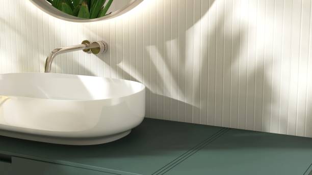 istock Modern white washbasin on dark green vanity counter countertop in sunlight on cream tile wall bathroom 2149195597