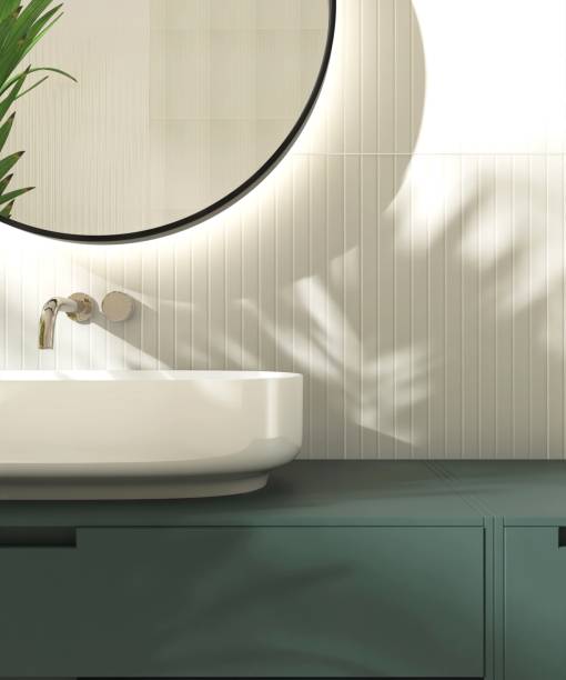 istock Modern white washbasin on dark green vanity counter countertop in sunlight on cream tile wall bathroom 2149195614