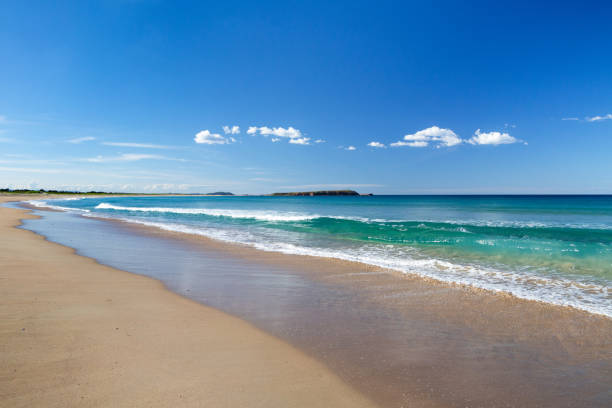 istock Beautiful blue ocean shoreline with island under blue sky 2149196029