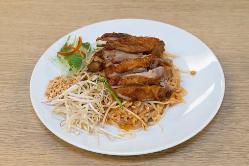 Table top of plate of Pad Thai Crispy Duck.