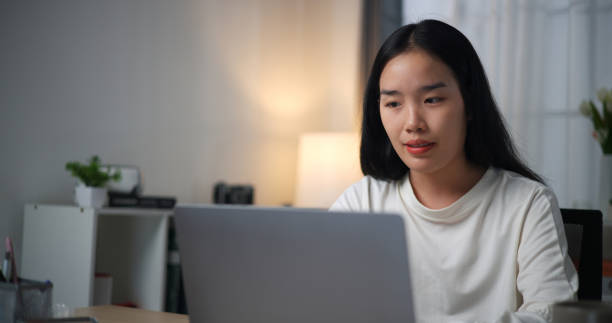 istock Woman using laptop at table at home. 2149197468