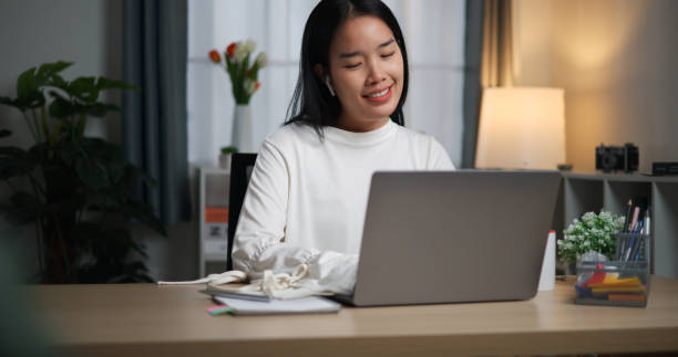 istock Young woman talking in work meeting using laptop at home. 2149197656