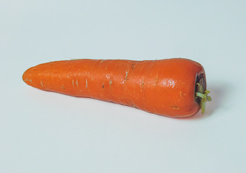 the young men eat red carrot .