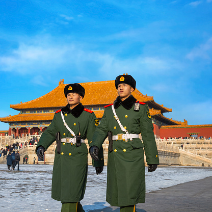 Beijing, China - Jan 9 2020: Unidentified Chinese military guards patrol on the courtyard of Taihedian (Hall of Supreme Harmony) in the Forbidden City