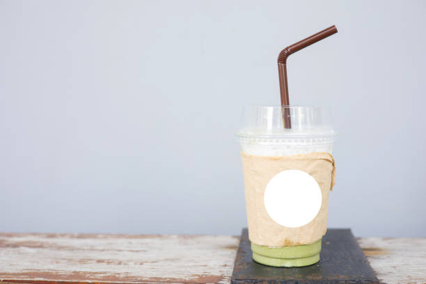 istock Plastic cup with green tea placed on a wooden table 2149199932