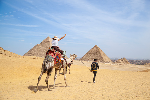 Giza area , Cairo,  Egypt- March 15, 2024
Tourists visit the pyramids with camels