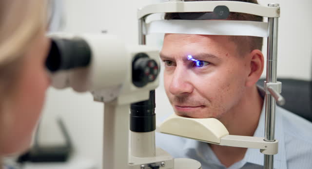 Closeup, slit lamp or eye in glaucoma, exam or ophthalmology as visual, healthcare or treatment. Optometrist, customer or medical technology to measure, assess or cornea by specialist consultation