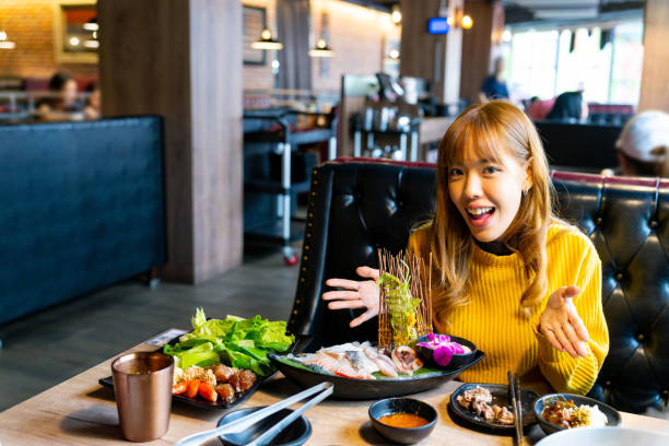 istock Asian woman having lunch eating hot pot at restaurant 2149202413