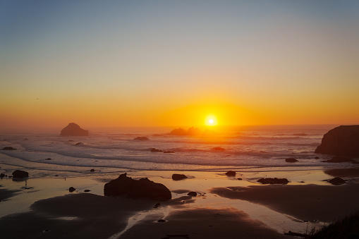 Serene view of a vibrant sunset over the Pacific Ocean shot from a scenic viewpoint in Bandon, Oregon.