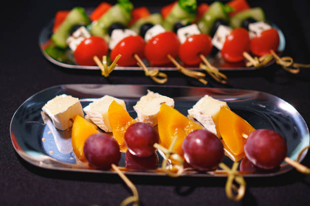 Assorted canapes on metal trays. Delicious appetizers for a buffet. A variety of festive menus.