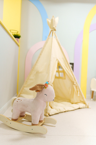Wigwam tent for children's room with rocking toy. Cute details for the interior.