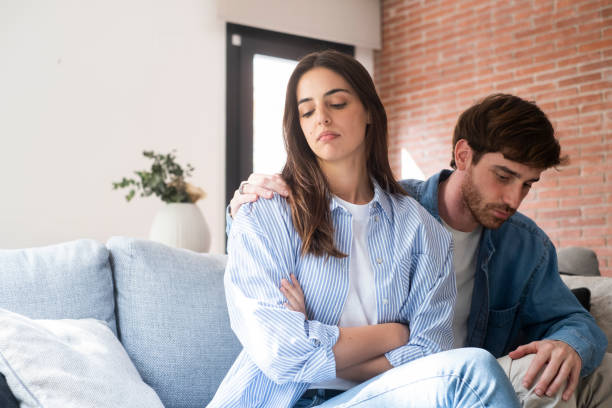 istock Sad and thoughtful girl thinking about relationship problems sitting on sofa with offended boyfriend, conflicts in marriage, upset couple after dispute, making decision to break up and divorce. Cheat 2149205732
