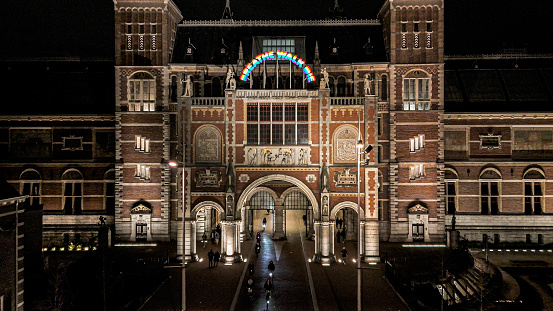 aerial view of the Rijksmuseum in Amsterdam at night, people cycling in tunnel, people cycling and exploring the city during christmas holidays, bike path with bike lights in Amsterdam city center, Aerial view of Amsterdam\n\nThe Rijksmuseum is the national museum of the Netherlands dedicated to Dutch arts and history and is located in Amsterdam.The museum is located at the Museum Square in the borough of Amsterdam South.