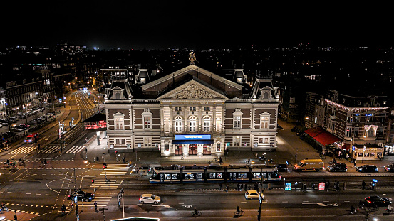 Aerial view of Het Concertgebouw in the Museumplein at night, Aerial view of crowded square of Amsterdam city at night\n\nThe Royal Concertgebouw is a concert hall in Amsterdam, Netherlands. The Dutch term \