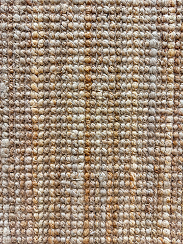 Macro shot of textured jute rug with natural beige and brown tones for  interior design and home decor. High quality photo