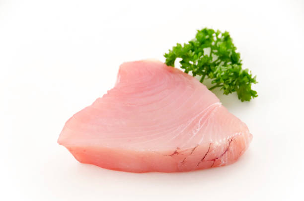 istock Fresh tuna fish fillet steaks with parsley isolated on white background 2149207665