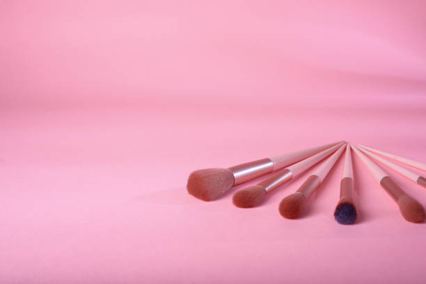 Set of makeup brushes on pink background. Makeup concept.