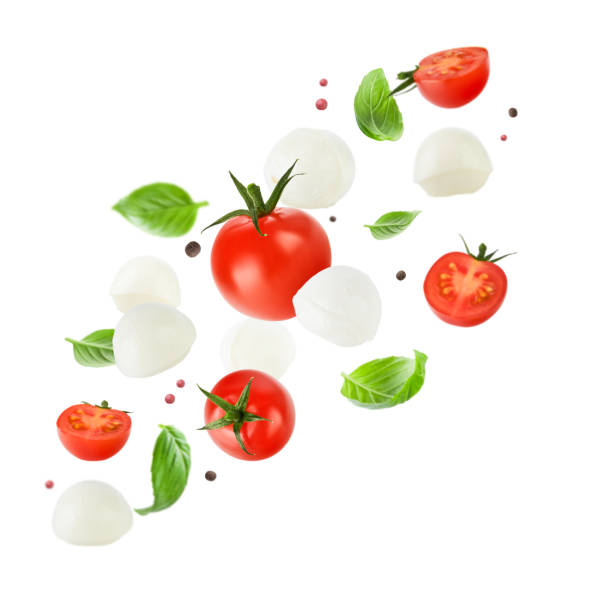 istock Flying mozzarella cheese balls, tomatoes, basil leaves and peppercorns for caprese salad isolated on white background. Mockup for advertising or product packaging design. Perfect retouched. 2149208456