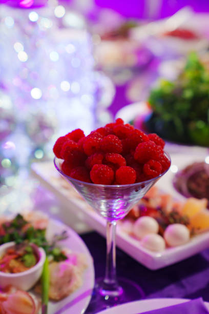istock A glass of bowl with fresh raspberries on the served table. 2149209098