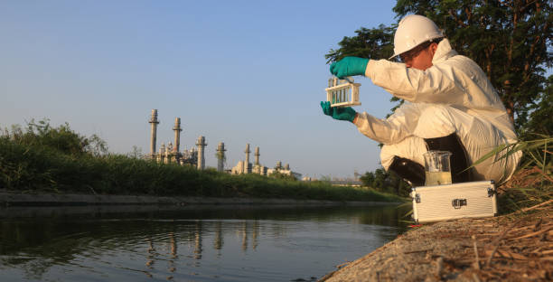 Environment engineers sample and test toxic wastewater from factories, environment control in the industrial estate