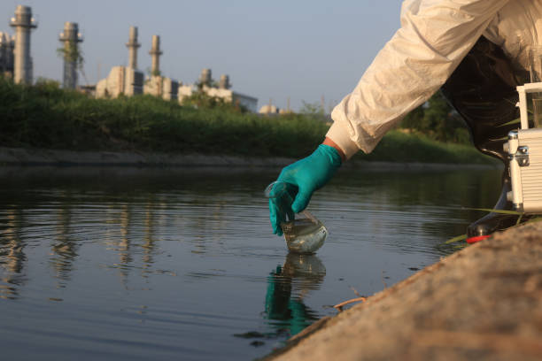 istock Close-up scientist hand with nitrile glove collect sample wastewater into a flask for laboratory water analysis, industrial and environmental concept 2149209864