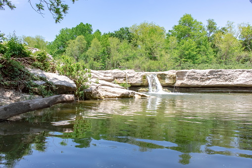 Waterfall and mountain cedar forest rock view in McKinney Falls State Park Austin Texas