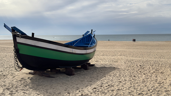 Runswick Bay, England - August 27, 2015: A Finnmaster 4900clx speedboat anchored close to the beach at Brunswick Bay.