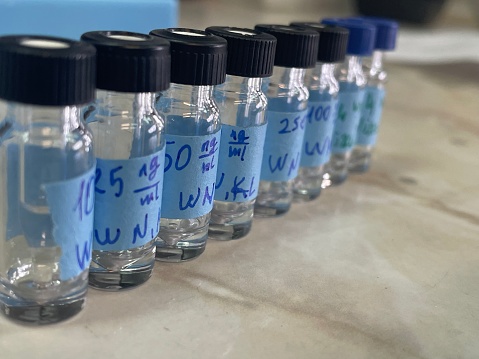 several special glass jars for curve analysis and calibration in the toxicology laboratory. different concentrations of hazardous substances in a row