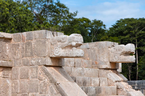 istock Two large snake heads carved from stone at the ancient Mayan ruins at Chichen Itza, Mexico. 2149212331