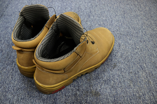 Photo of old, worn, light brown leather shoes usually worn to protect the feet