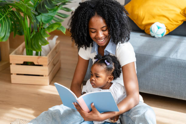 istock Mother and child reading together at home 2149212869