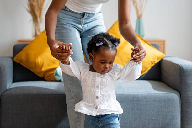 istock Toddler girl learning to walk with mother's help 2149212898