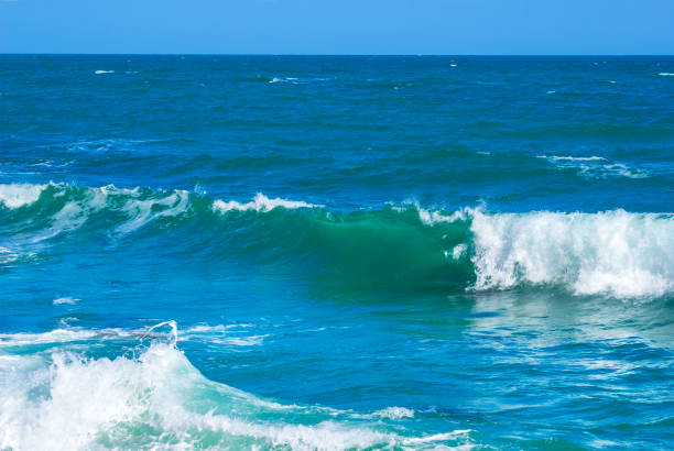 Crashing white waves at the beach.