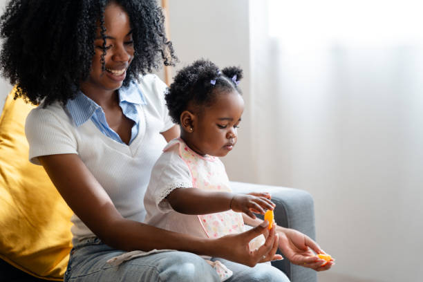 istock Mother and daughter playing together at home 2149213264
