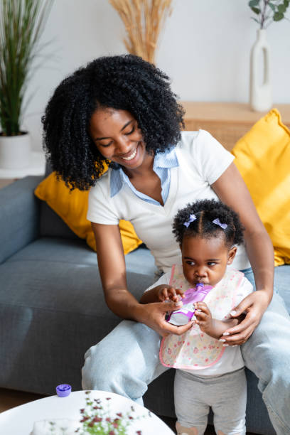 istock Joyful mother playing with baby at home 2149213270
